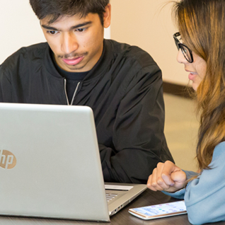 Two students using a computer.