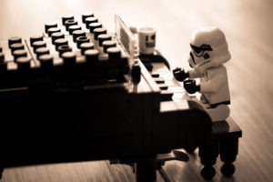 A storm trooper lego toy playing a lego piano