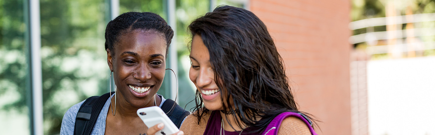 students looking at a phone together