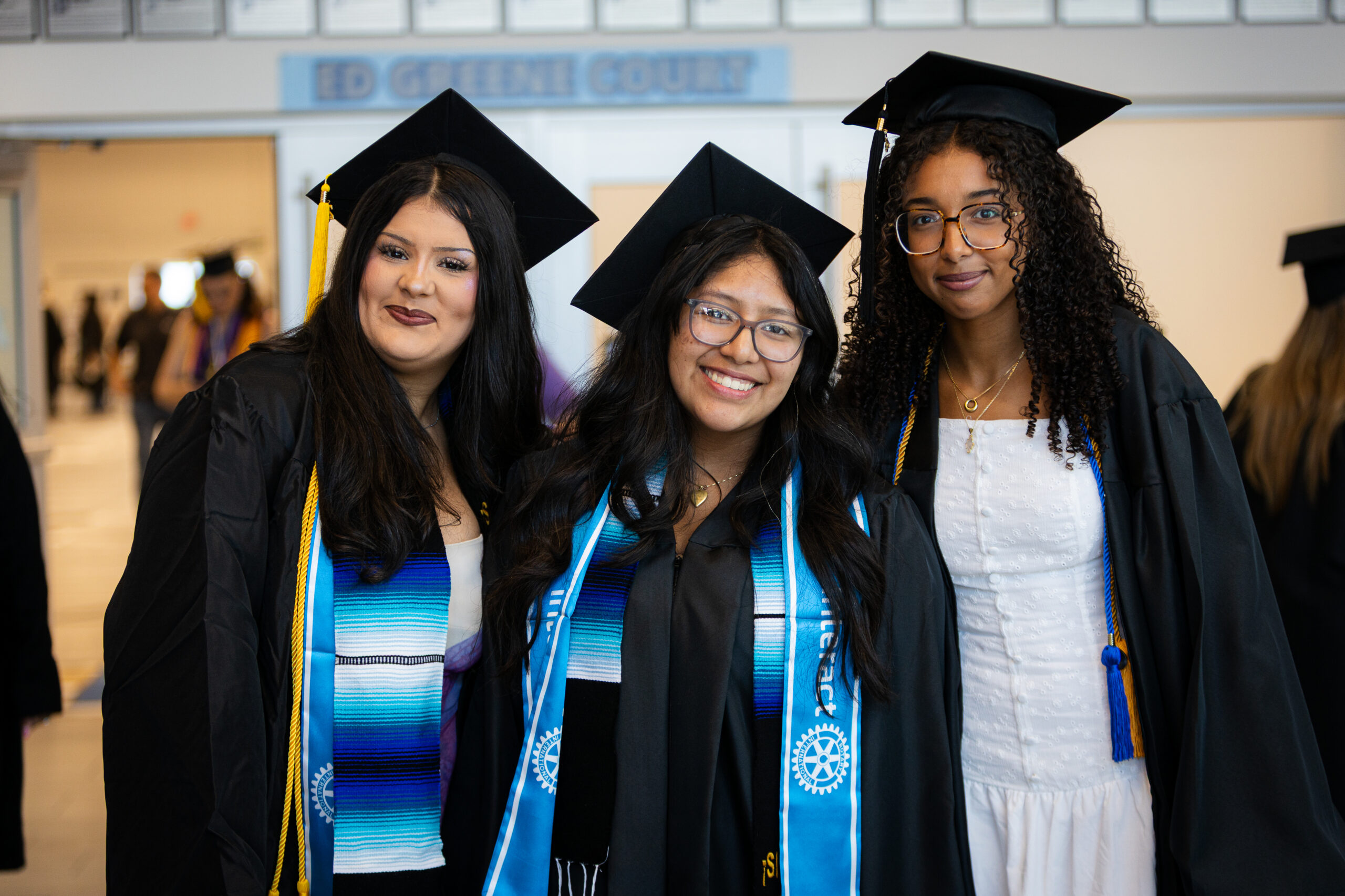 Three student graduates 2026 graduation